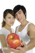 healthy attractive couple with their apple