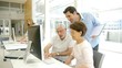 Group of senior people with trainer in front of computer