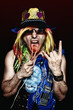 Crazy rock star burning his tongue with hot electric heater