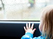 Girl in a car is looking out the window