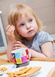A small girl is eating cookies