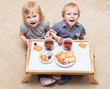Funny children are eating dessert