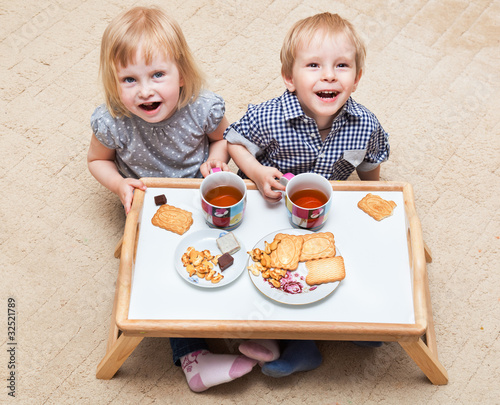 Photo: Funny children are eating dessert Funny children are eating dessert