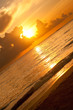 Bright sunrise in early morning with sand beach and ocean Bright sunrise in early morning with sand beach and ocean