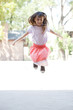 Girl skipping rope outdoors