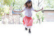Girl skipping rope outdoors