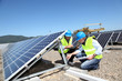 Photo: Engineers checking solar panels running Engineers checking solar panels running