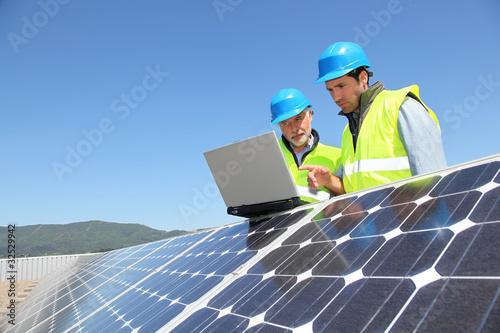 Photo: Engineers checking solar panel setup Engineers checking solar panel setup