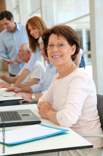 Photo: Senior woman attending business training Senior woman attending business training
