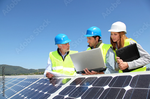 Photo: Group of engineers meeting on building roof Group of engineers meeting on building roof