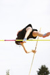 Photo: Female athlete competing in the pole vault Female athlete competing in the pole vault