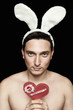 Young guy with naked chest and white bunny ears