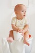 Foto: Cute baby sitting on a toilette Cute baby sitting on a toilette