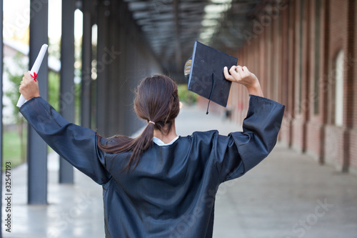 Photo: Happy graduate holding mortarboard and diploma Happy graduate holding mortarboard and diploma