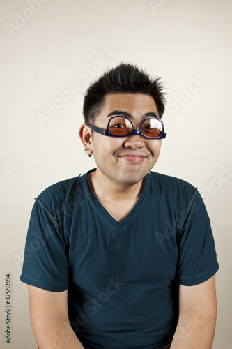 Photo: Funny face, A man wear eyeglass upside down smile. Funny face, A man wear eyeglass upside down smile.