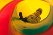 Boy child in tube slide