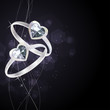 Vector: Two silver rings with gem on luxury black background Two silver rings with gem on luxury black background
