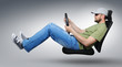 Foto: Unreal driver wearing sun glasses rides on an office chair Unreal driver wearing sun glasses rides on an office chair