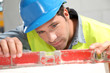 Photo: Worker using level on building site Worker using level on building site
