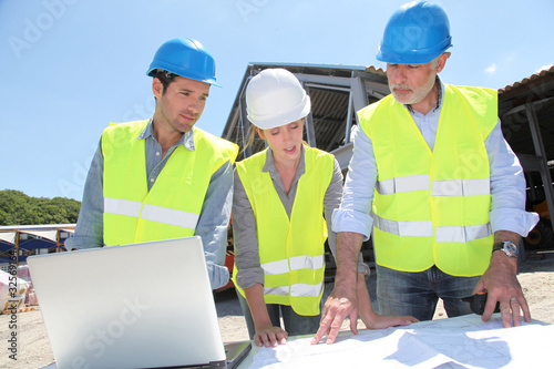 Photo: Industrial people working on building site Industrial people working on building site