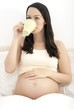Pregnant woman drinking mug of tea/coffee