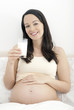 Pregnant woman enjoying glass of milk