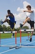 Photo: Men Running Down A Track And Jumping Over Hurdles Men Running Down A Track And Jumping Over Hurdles