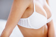 Closeup of a busty woman in white lingerie