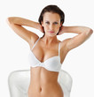 Sensuous young woman posing in white lingerie
