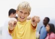 Happy teen boy pointing at you with friends at back