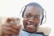 Closeup of a happy black boy listening to music on headphones