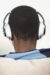 Closeup rear view of a boy listening to music on headphones
