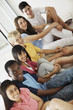 Teenagers sitting together in a line and smiling