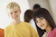 Pretty young girl at school with friends at back