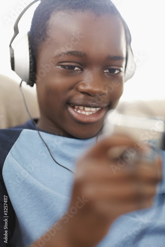 Photo: Black boy enjoying music on headphones Black boy enjoying music on headphones