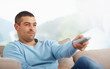 Smart young guy watching television