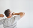 Young man yawning in morning - Rear view