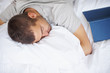 Tired young man sleeping in his bed
