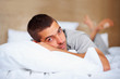 Photo: Young man lying on the bed - Indoor Young man lying on the bed - Indoor