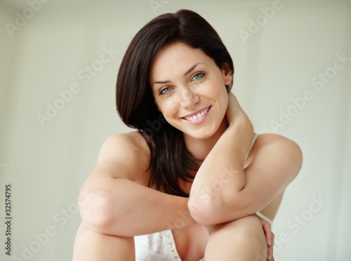 Photo: Gorgeous young female brunette sitting with a smile Gorgeous young female brunette sitting with a smile