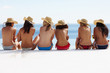 Foto: Rear view of topless young female sitting at the beach Rear view of topless young female sitting at the beach