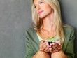 Save the environment - Young lady holding a small plant