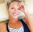 Smiling young lady lying on couch