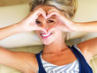 An attractive woman looking through a heart sign