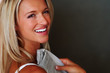 Beautiful young female smiling holding newspaper