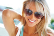 Happy young woman posing with sun glasses