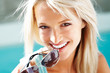 Cute young female holding googles in mouth
