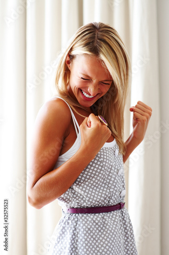 Photo: Excited young woman celebrating success Excited young woman celebrating success
