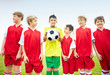Rival player holding ball amid a group of soccer team on field
