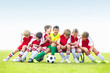 Mischievous soccer kids having fun on bench - copyspace